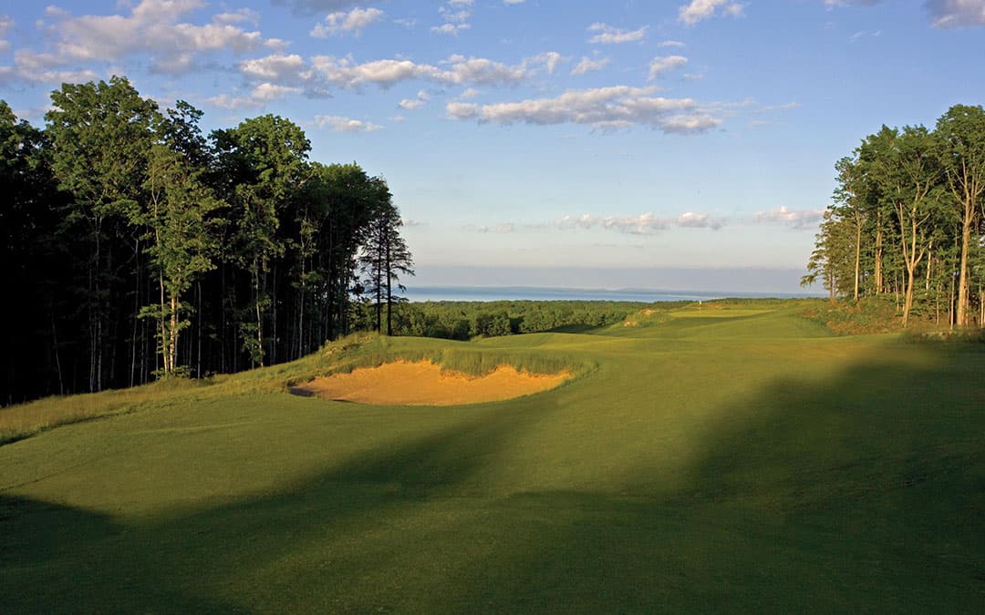 A fairway at Marquette Golf Club's Greywalls course, with Lake Superior on the horizon