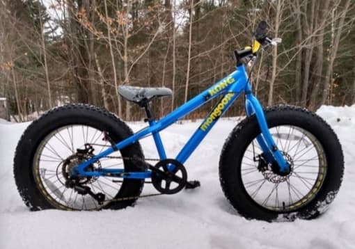 A fat bike ready to rent from MQT Bike Rentals, parked in the snow